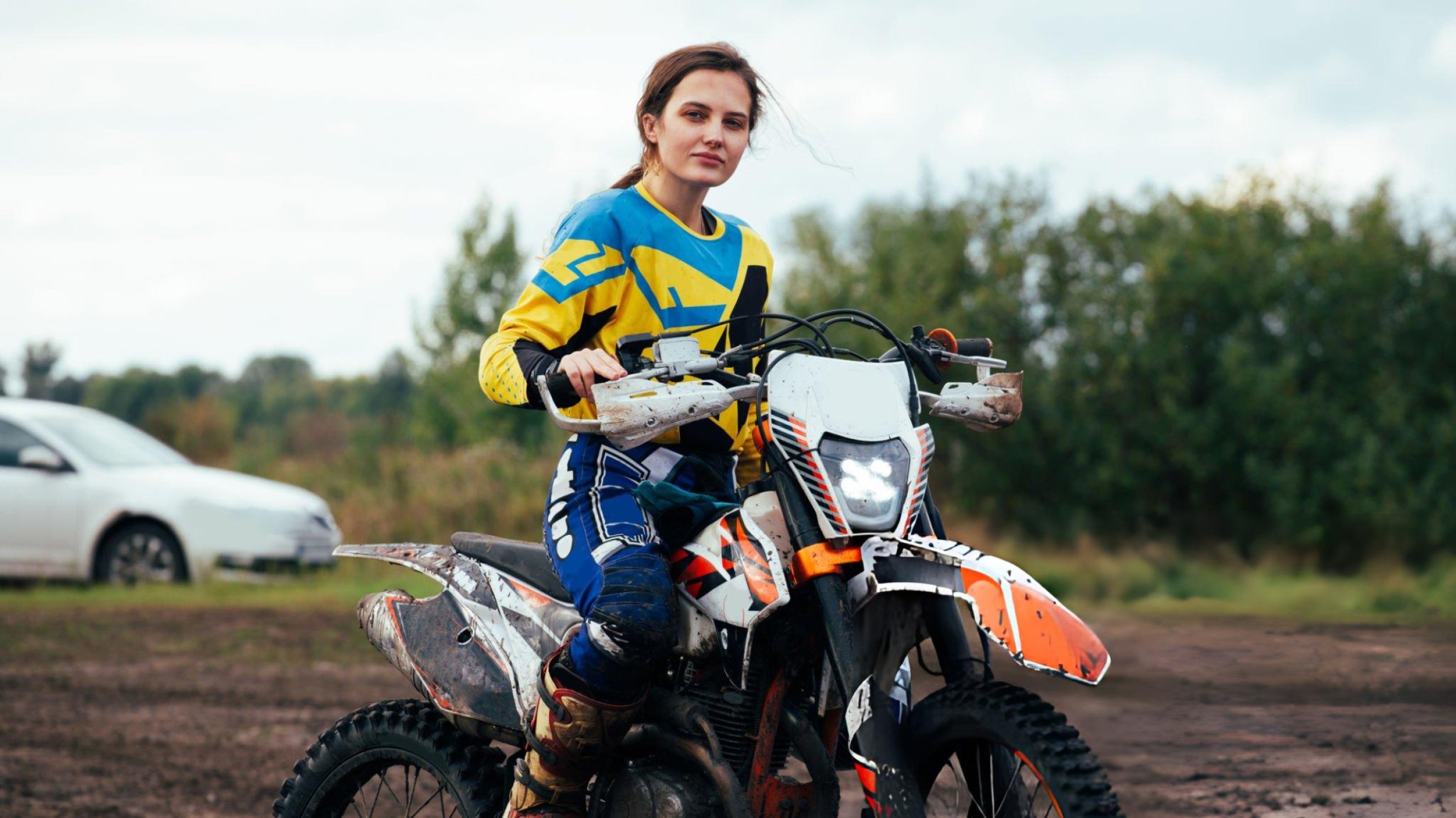 Hero image showing multiple dirt bike racing types: motocross stadium jumps, supercross arena, desert rally, and enduro forest trail