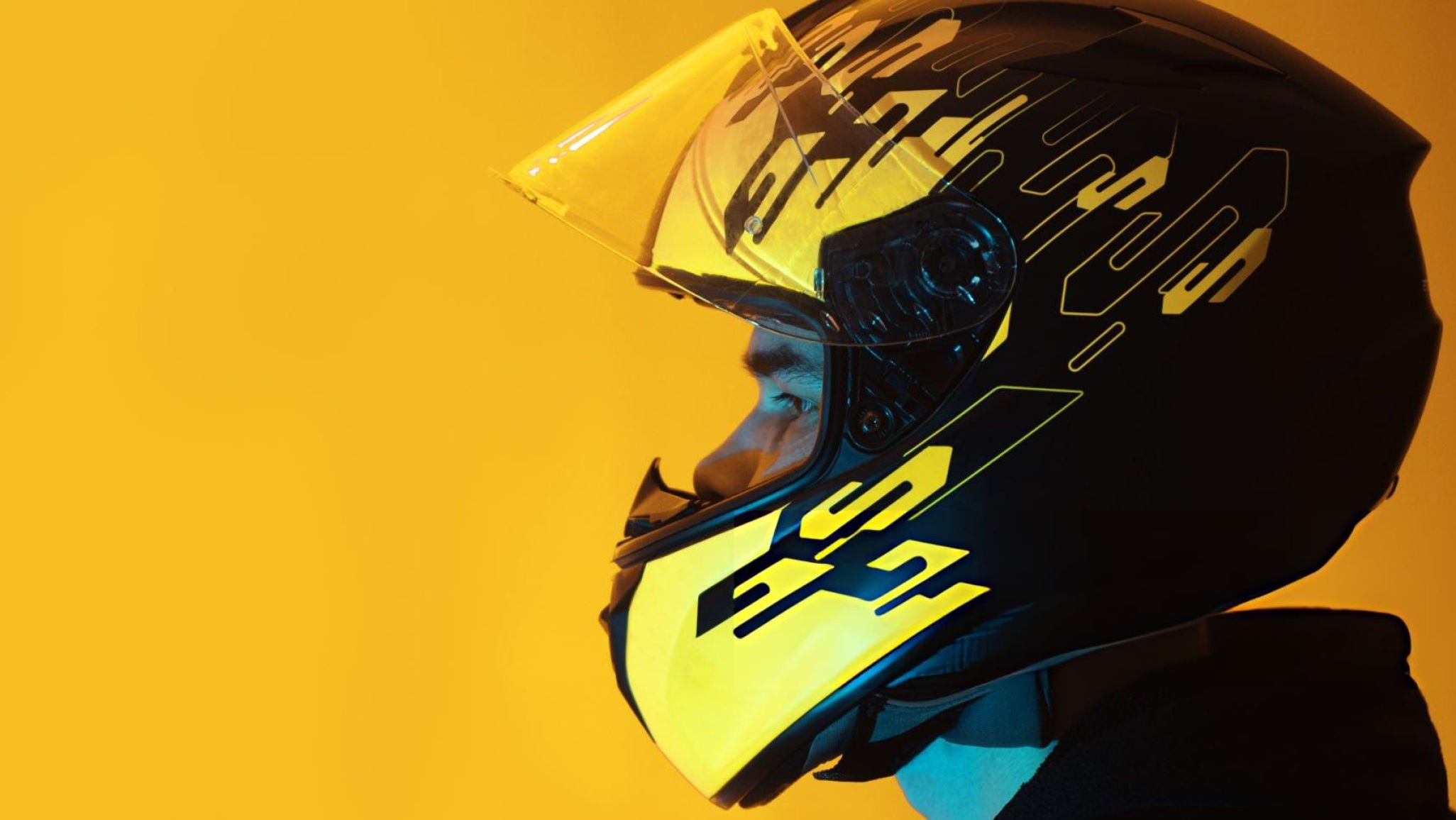 Person measuring head circumference with soft tape for motorcycle helmet sizing